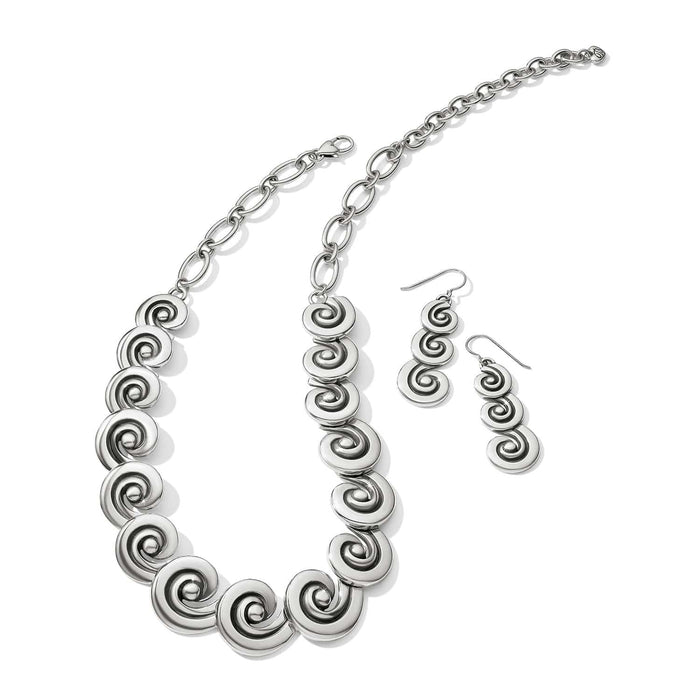 Brighton necklace and drop earrings set with silver-plated spiral disc links and chain closure on a white background
