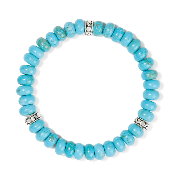 Brighton beaded stretch bracelet with turquoise stone beads and silver-plated scroll accent spacers on a white background