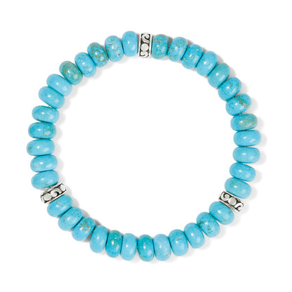 Brighton beaded stretch bracelet with turquoise stone beads and silver-plated scroll accent spacers on a white background