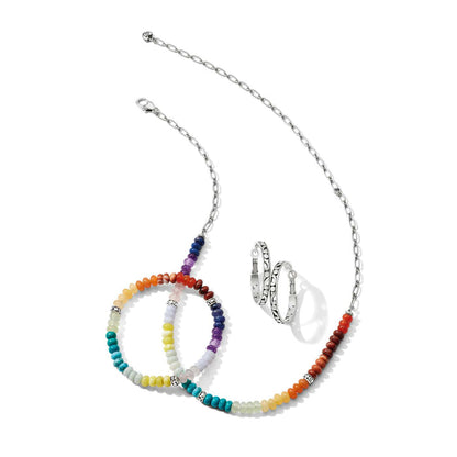 Brighton silver-plated jewelry styled with rainbow beaded bracelets, matching beaded necklace, and engraved hoop earrings on white background