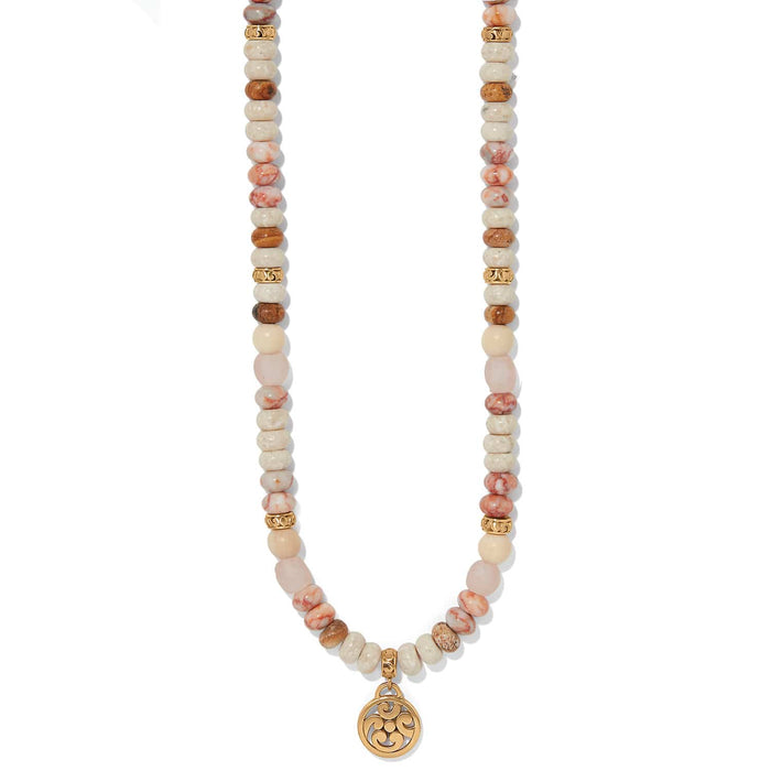 Brighton beaded necklace with web jasper, white howlite, picture jasper, rose glass, wood beads, and gold pendant on a white background