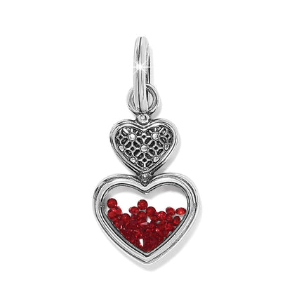 Brighton double heart charm with silver-plated filigree top and red crystals inside lower heart on a white background