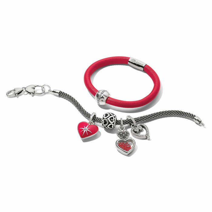 Brighton silver-plated charm bracelet and red leather bracelet with heart charms and crystals on a white background