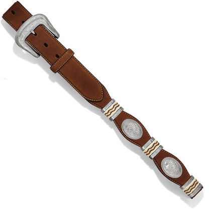 Brighton brown leather belt with engraved silver-tone buckle, oval conchos, and woven accents on a white background