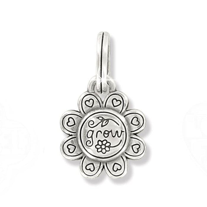 Brighton flower charm with silver-plated petals, heart accents, and engraved grow inscription on a white background