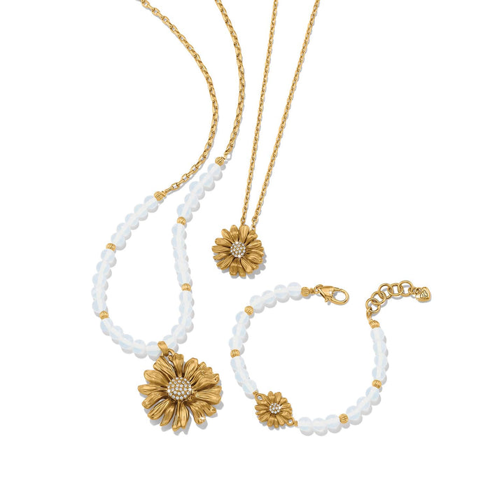 Brighton gold-plated daisy necklaces and bracelet with crystal centers and opalescent beaded accents on a white background
