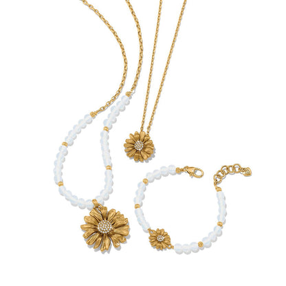 Brighton gold-plated daisy necklaces and bracelet with crystal centers and opalescent beaded accents on a white background