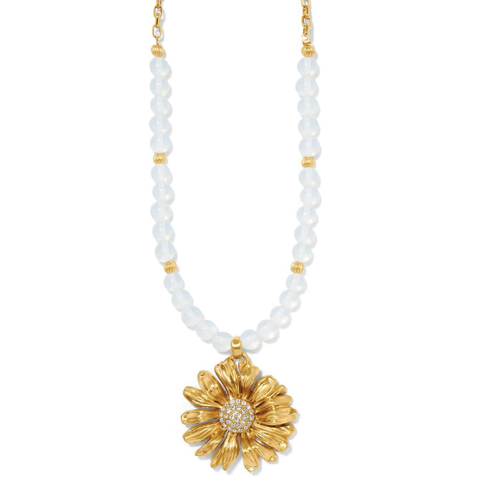 Brighton beaded necklace with white beads and gold-plated daisy pendant featuring crystal center on a white background