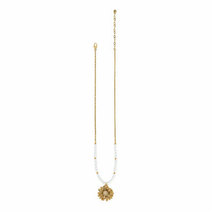 Brighton gold-plated necklace with white beads and crystal-accented daisy flower pendant on a white background