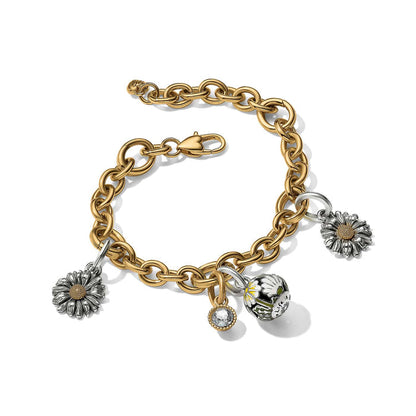 Brighton charm bracelet with two-tone daisy charms, crystal drop, and floral bead on gold chain, white background