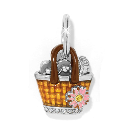 Brighton charm shaped like an orange enamel basket with pink flower, crystal accents, and silver-plated finish on a white background