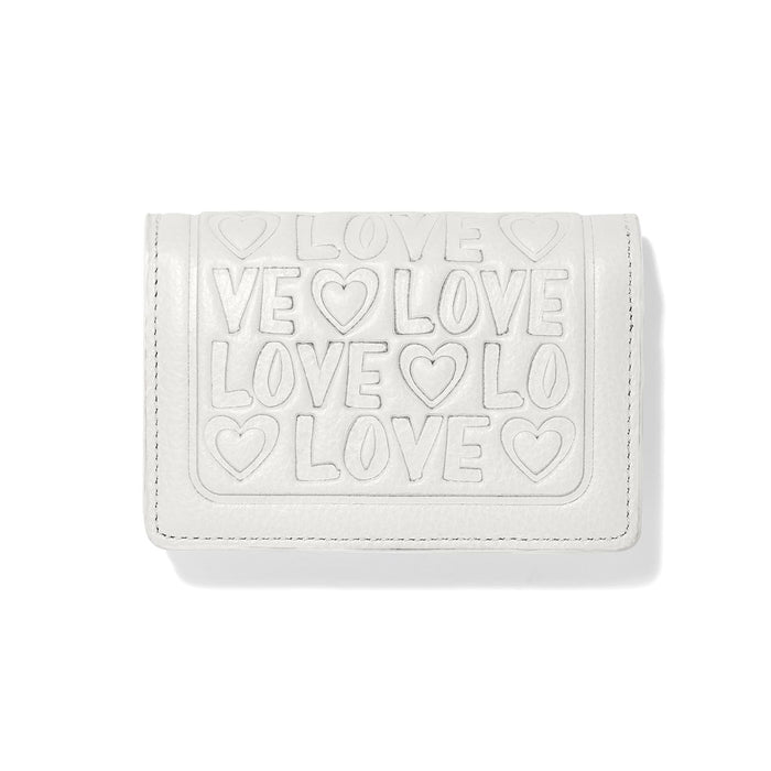 Brighton wallet in white leather with embossed LOVE lettering and heart motifs on a white background