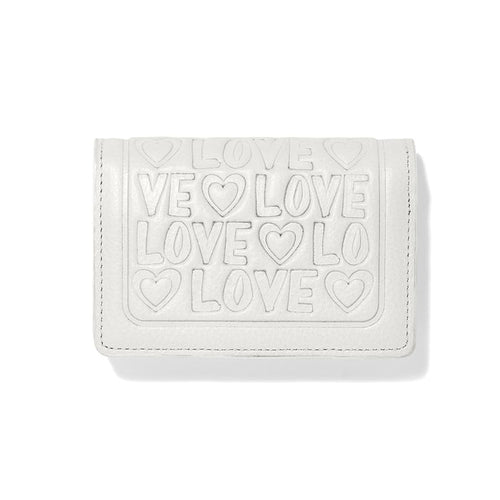 Brighton wallet in white leather with embossed LOVE lettering and heart motifs on a white background