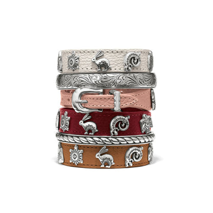 Brighton leather bracelets stacked in cream, pink, red, and tan with silver-plated animal charms and buckle on a white background