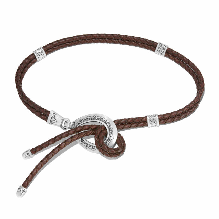 Brighton braided brown leather necklace with silver-tone ring pendant and decorative station accents on a white background