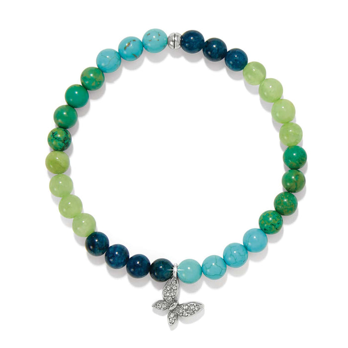 Brighton beaded bracelet with green and blue stone beads and silver-plated crystal butterfly charm on a white background