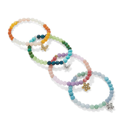 Brighton beaded bracelets in multicolor stones with crystal butterfly and flower charms in silver and gold on a white background
