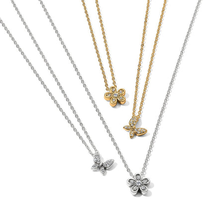 Brighton pendant necklaces in silver-plated and gold-plated finishes with crystal butterfly and flower charms on a white background