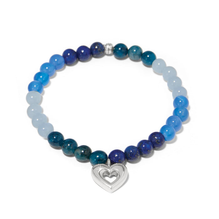 Brighton beaded bracelet with blue gemstone beads and silver-plated open heart charm on a white background