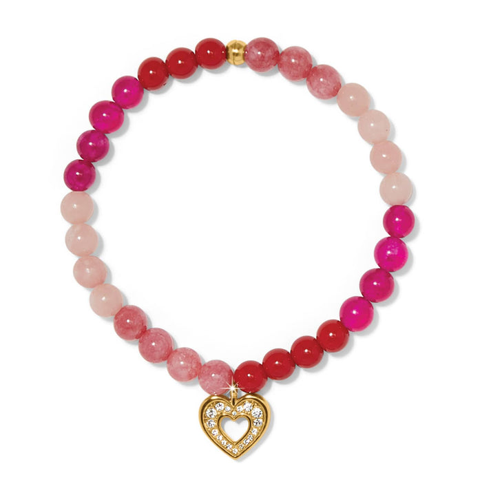 Brighton beaded bracelet with pink and red stones featuring gold-plated heart charm with crystal accents on a white background
