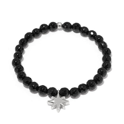 Brighton beaded bracelet with faceted black beads and silver-plated star charm on a white background