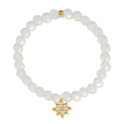 Brighton beaded stretch bracelet with opalescent beads and gold-plated star charm with crystal accents on a white background