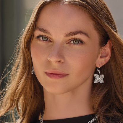 Model wearing Brighton silver-plated drop earrings with floral design and crystal accents on the hook
