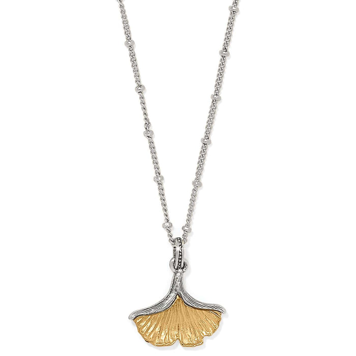 Brighton pendant necklace with two-tone ginkgo leaf charm on silver-tone beaded chain on a white background
