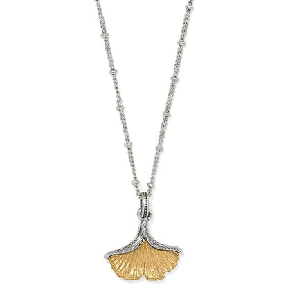 Brighton pendant necklace with two-tone ginkgo leaf charm on silver-tone beaded chain on a white background