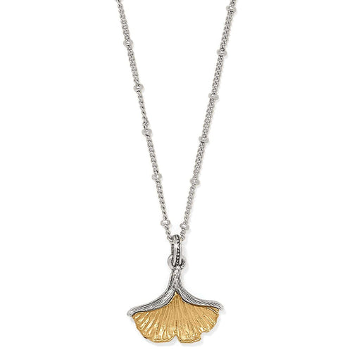Brighton pendant necklace with two-tone ginkgo leaf charm on silver-tone beaded chain on a white background