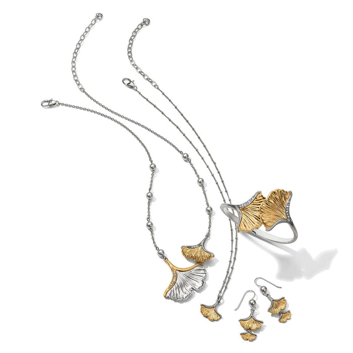 Brighton two-tone ginkgo leaf jewelry set styled with silver chains and gray beaded accents on a white background