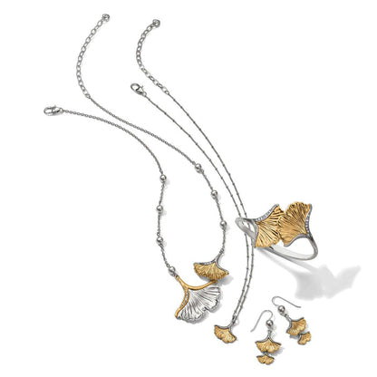 Brighton two-tone ginkgo leaf jewelry set styled with silver chains and gray beaded accents on a white background