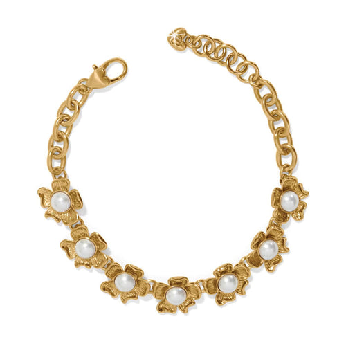 Brighton gold-plated chain bracelet with glass pearl cabochon flower stations and heart-shaped clasp on a white background