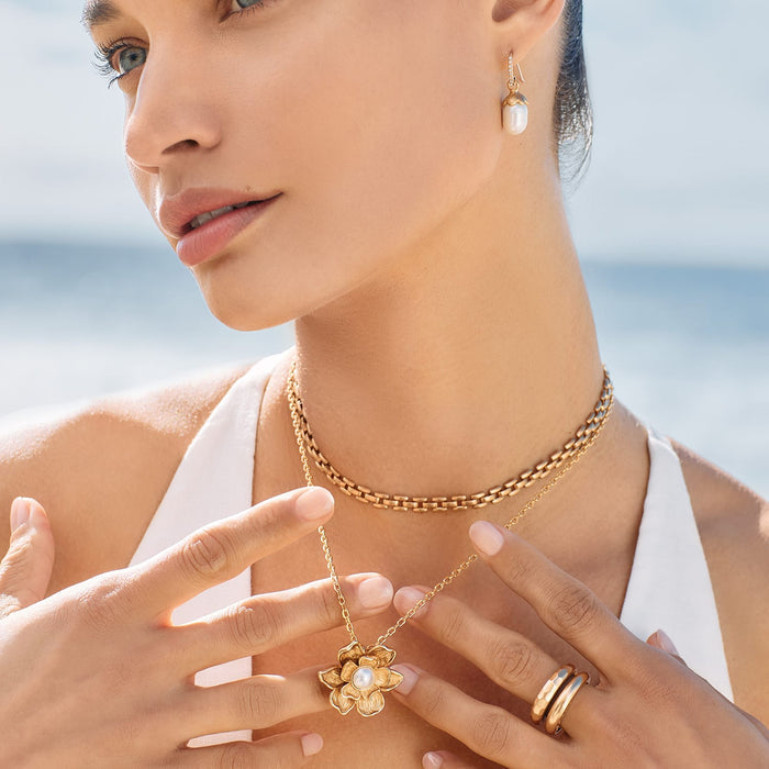 Model wearing Brighton pearl drop earrings with crystal accents and coordinating Brighton accessories including layered necklaces