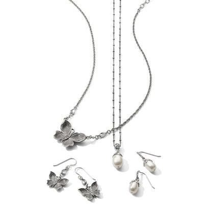 Brighton silver-plated butterfly necklace with pearl pendant necklace and matching butterfly and pearl drop earrings on a white background