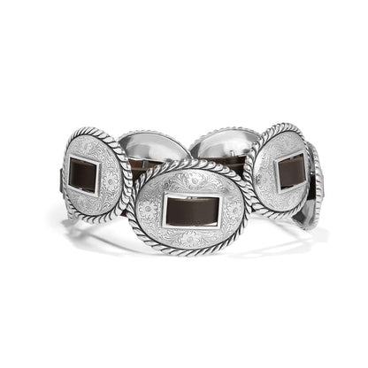 Brighton leather belt with large oval silver-tone engraved concho medallions and rope-edge borders on a white background