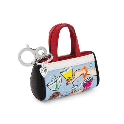 Brighton mini leather handbag keychain with cocktail print, red handles, and silver-tone clip on a white background
