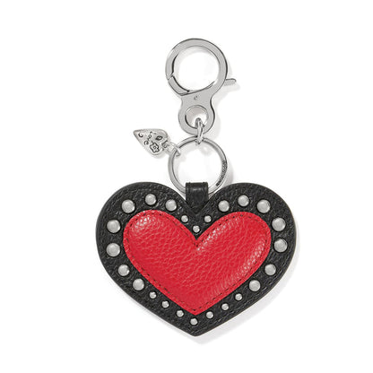 Brighton heart bag charm with red leather center, black studded leather border, and silver-tone clasp on a white background