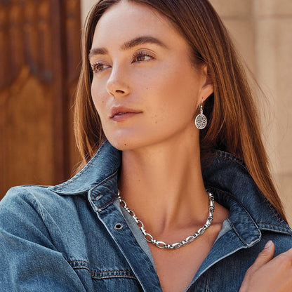 Model wearing a Brighton silver-plated link necklace paired with ornate silver-plated filigree drop earrings