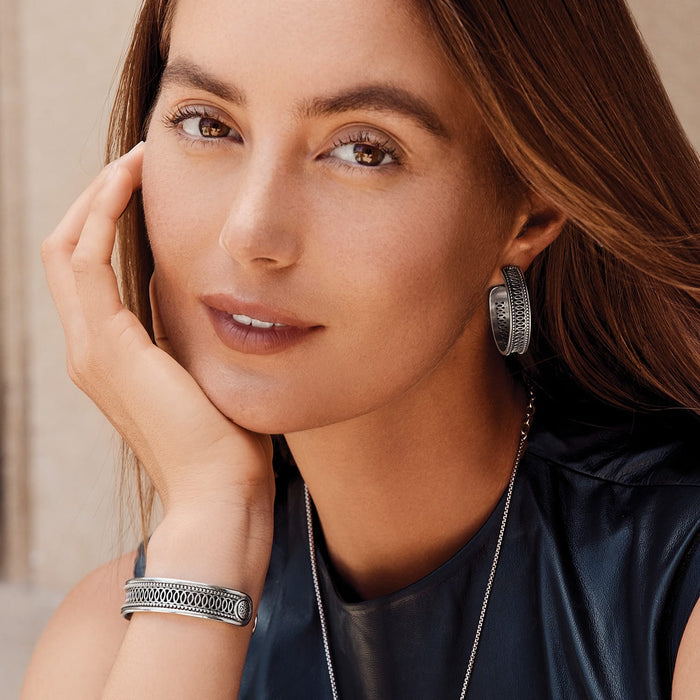 Model wearing Brighton silver-plated hoop earrings with dotted openwork detail and coordinating Brighton cuff bracelet and necklace