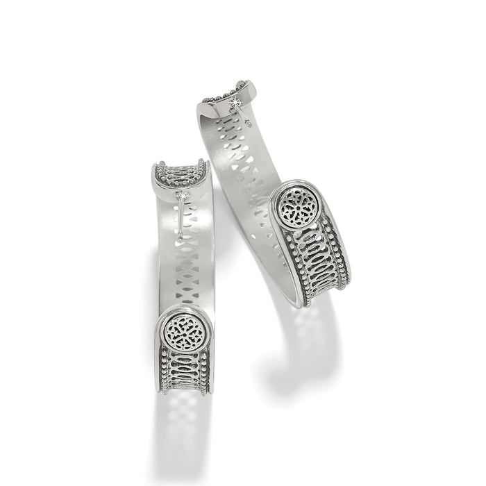 Brighton hinged cuff bracelets with silver-plated finish, openwork medallion accents, and beaded detailing on a white background