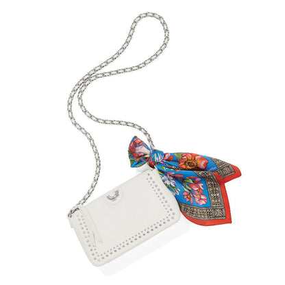 Brighton crossbody handbag in white with silver-tone studs, chain strap, and floral printed scarf on a white background