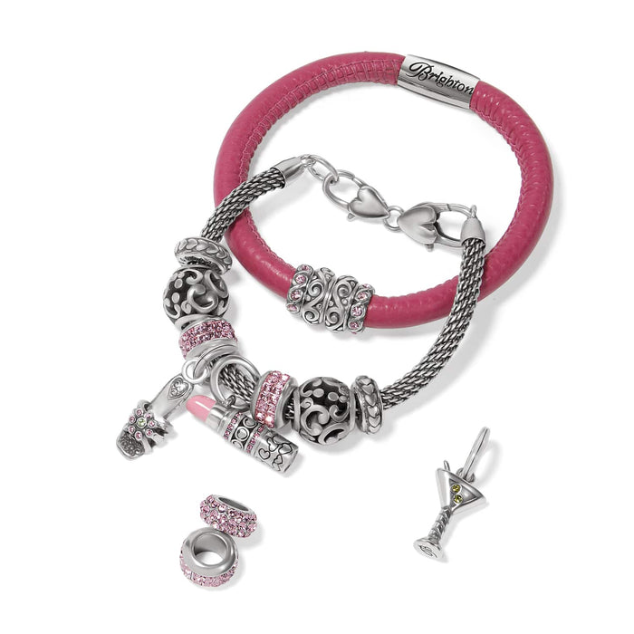 Brighton charm bracelets styled with silver-plated charms, pink crystal beads, and enamel accents on a white background