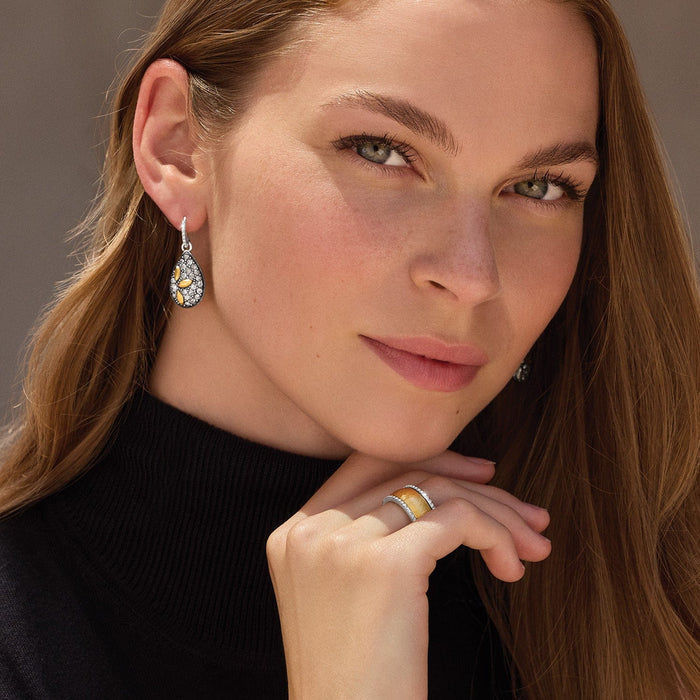 Model wearing Brighton silver-tone teardrop earrings with crystal pavé and gold-plated leaf accents, paired with crystal ring