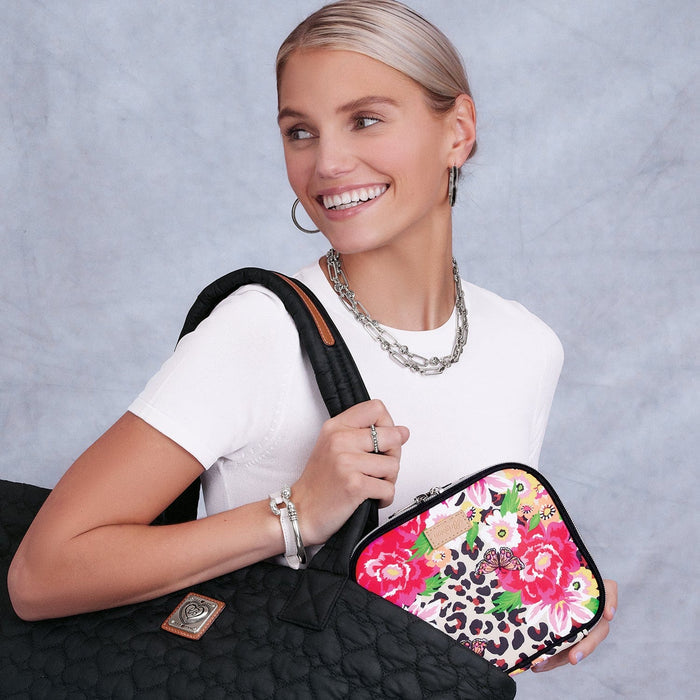 Model with a Brighton black quilted tote and floral leopard print pouch with butterfly accent