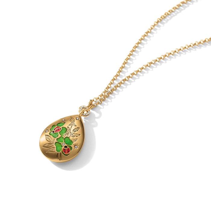 Brighton gold-plated teardrop pendant necklace with green enamel clovers, ladybugs, and crystal accents on a white background