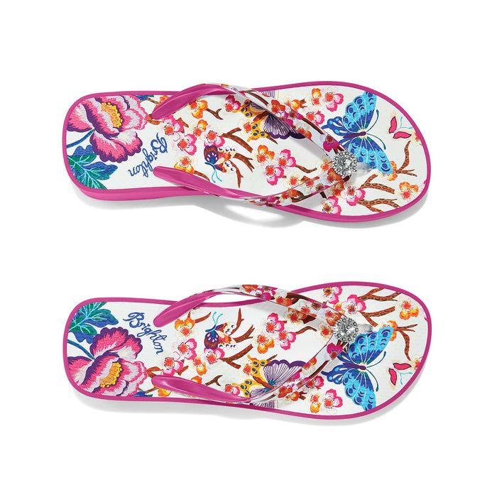 Brighton pink rubber flip-flop sandals with floral and butterfly print and crystal medallion accent on a white background