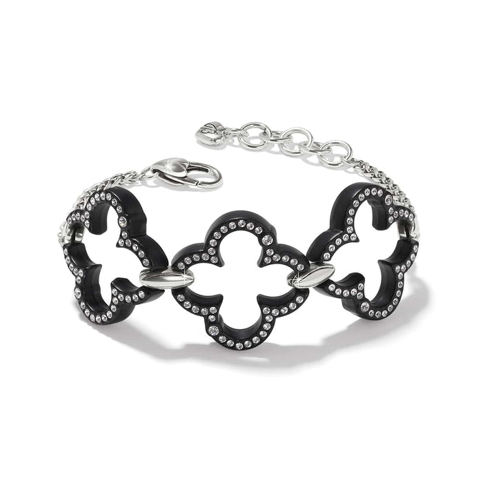 Brighton bracelet with black lacquer quatrefoil links, crystal accents, and silver-plated chain clasp on a white background