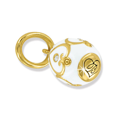 Brighton gold-plated charm with white enamel, scrollwork detail, heart emblem, and crystal accents on a white background