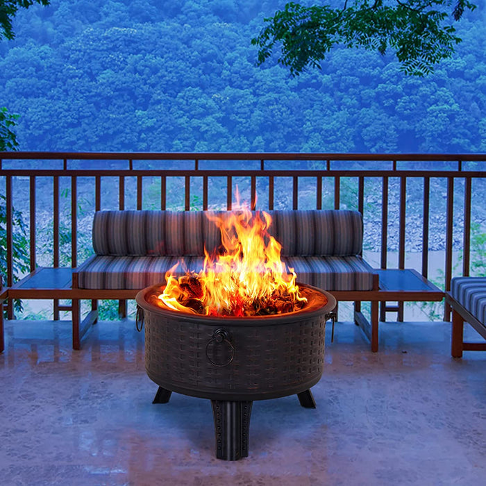 Fire pit on a patio with striped cushioned chairs and a scenic background